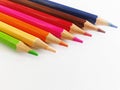 An image of several colored pencils neatly lined up on a white background