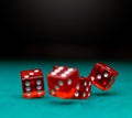 Image of several red dice falling on green table Royalty Free Stock Photo