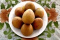 Sapodilla tropical fruit on a plate on the table Royalty Free Stock Photo