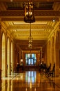 Shiny golden hallway with rainbow flags framing doorway at end of hall Royalty Free Stock Photo