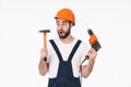 Shocked young man holding drill and hammer Royalty Free Stock Photo