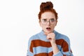 Image of shocked and worried ginger girl in glasses react to upsetting news, open mouth and stare startled at camera