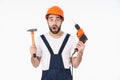 Shocked young man holding drill and hammer Royalty Free Stock Photo