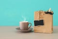 Image of shopping bag and cup of coffee, present for dad. Father`s day concept.