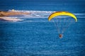 Image shot from slightly above a Paraglider at an altitude of about 500 feet headed toward people on beach and lifeguard tower
