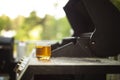 Image of a shot of whiskey on a grille on a porch