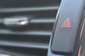 the car\'s hazard warning light button, easily recognizable with its red triangle symbol on a black background Royalty Free Stock Photo