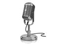 A sleek vintage-style microphone standing on a reflective metallic base with a coiled cord Royalty Free Stock Photo
