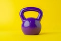 Vibrant Purple Kettlebell on Yellow Royalty Free Stock Photo