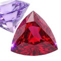 A close-up view of a vibrant red triangular gemstone next to a clear diamond Royalty Free Stock Photo