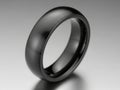 A sleek and modern black ring with a smooth and shiny finish displayed against a white background Royalty Free Stock Photo