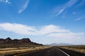 Image showcases a desolate stretch of Route 66, the iconic American highway, located in Nevada, USA