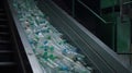 Plastic Bottle Recycling at PET Recycling Plant: Escalator Conveyor in Action, A modern facility for sorting and waste recycling Royalty Free Stock Photo