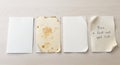 Four Paper Sheets Displayed on White Backdrop Featuring Clean Aged Spotted and Handwritten Note Aesthetic in Bright Studio Setting Royalty Free Stock Photo