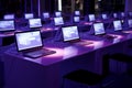 purple tech room with multiple monitors and laptops