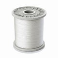 Large White Spool of Industrial Sewing Thread with Cylindrical Plastic Reel for Textile Applications Royalty Free Stock Photo