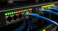 Close up view of a network switch with multiple blue ethernet cables connected and illuminated status lights indicating active Royalty Free Stock Photo