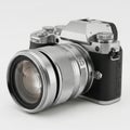 Classic silver and black dslr camera with large zoom lens attached Royalty Free Stock Photo