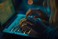 Woman working on illuminated laptop keys in dark environment at night
