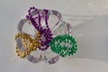 Traditional three color Mardi Gras beads abstract design on white background Royalty Free Stock Photo