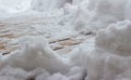 Partially snow shoveled wooden deck