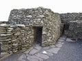 Ancient stone beehive hut colony of clochans, stone dry huts in rural Ireland Royalty Free Stock Photo