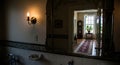 bathroom mirror reflects an elegant hallway view Royalty Free Stock Photo