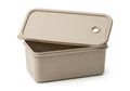 A beige plastic storage container with a hinged lid is open on a white background Royalty Free Stock Photo