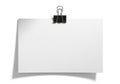 A blank sheet of paper clipped to a wall with a black binder clip Royalty Free Stock Photo