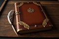 The image shows a brown leather journal on a wooden table with a feather quill on top Royalty Free Stock Photo