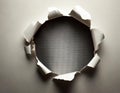 The image shows a circular hole torn in a sheet of white paper, revealing a dark background Royalty Free Stock Photo