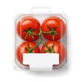 A clear plastic container with six ripe red tomatoes and green stems Royalty Free Stock Photo