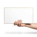 A hand holding a blank white rectangular object against a plain background Royalty Free Stock Photo
