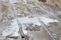 Partially thawed snow and ice covered wooden deck