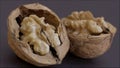 Close-up of walnuts cracked open on dark background - AI generated Royalty Free Stock Photo