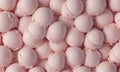 close-up view collection pink, round, and white objects arranged in grid-like pattern. Royalty Free Stock Photo