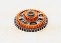Complex mechanical gear assembly with an orange and silver color scheme Royalty Free Stock Photo