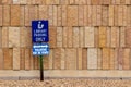 View of a library parking sign in front of an modern limestone wall with rough texture bricks Royalty Free Stock Photo