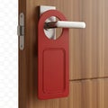 Red door handle with attached rectangular metal tag on wooden door Royalty Free Stock Photo