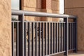 Modern limestone building wall with an attractive strong metal fence