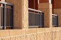 Modern limestone building wall with an attractive strong metal fence