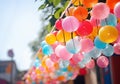 The image shows colorful garlands hanging outdoors, creating a festive and colorful atmosphere. Street festival.