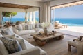 This image shows a cozy and functional living room filled with furniture, highlighted by a large window, A peaceful beach house