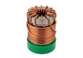 Close-up view of a copper coil inductor with green base and terminals Royalty Free Stock Photo