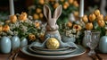 Easter table with ceramic bunny, yellow patterned egg, tulips, and green napkin. Set on stacked plates. Ideal for Easter Royalty Free Stock Photo