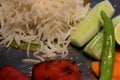 Food platter with rice, salad, lemon, rolls, green chili etc