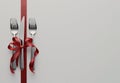 Fork and knife tied with a red ribbon isolated in the corner on white background with copy space Royalty Free Stock Photo