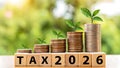 Growing money stacks with tax year 2026 wooden blocks display Royalty Free Stock Photo