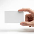 A hand holding a blank white card against a plain background Royalty Free Stock Photo