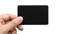 A hand holding a sleek black rectangular device against a plain background Royalty Free Stock Photo